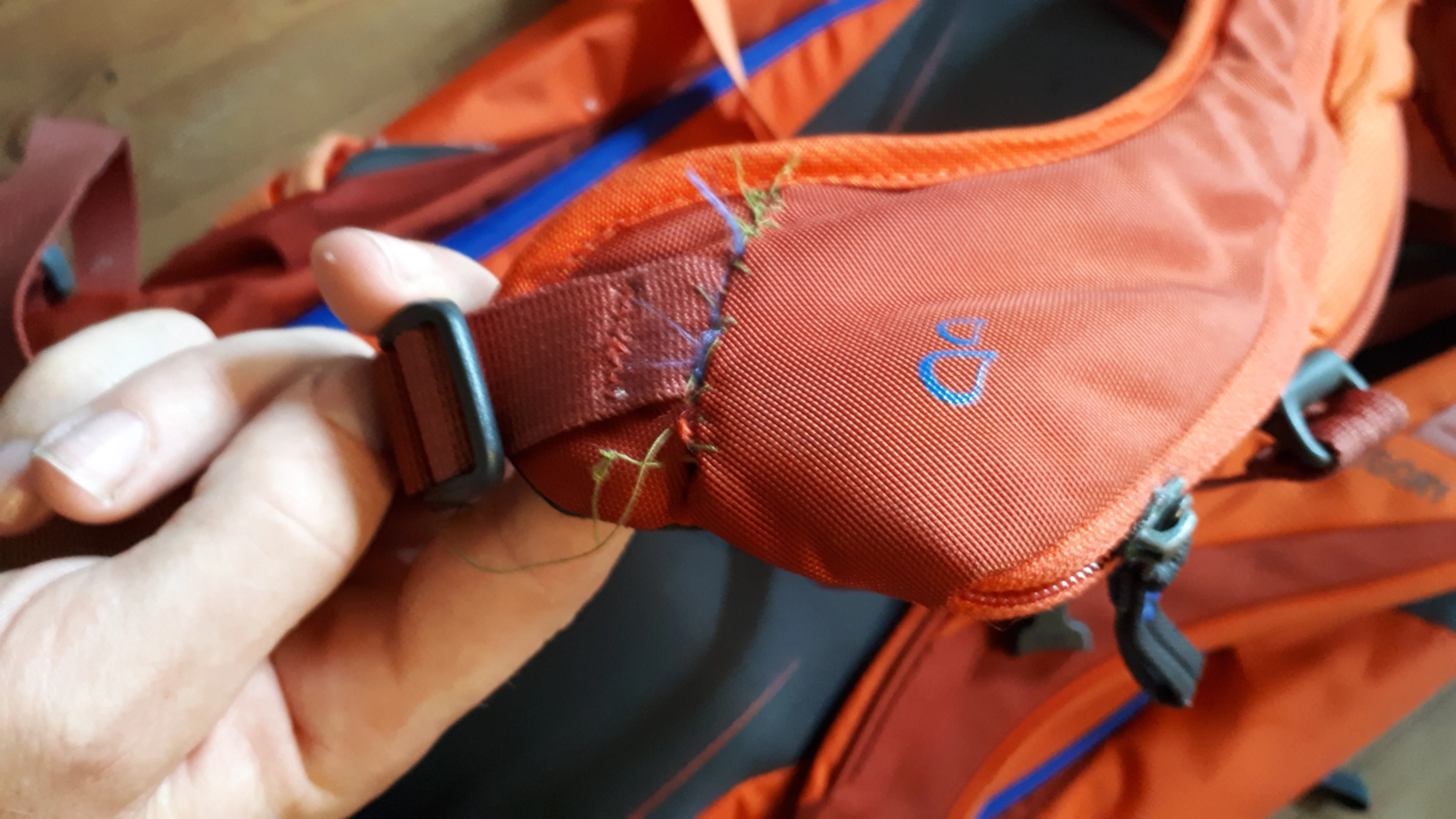 Emergency repair with needle and thread of a carrying strap on the pack.