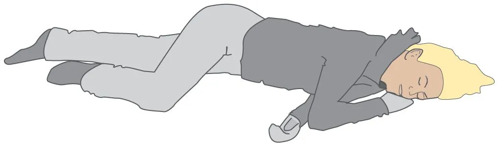 A person lying in the recovery position.