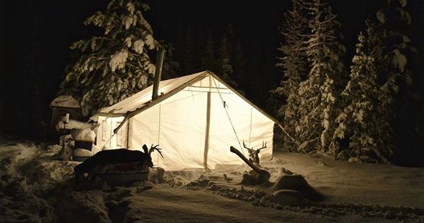 Tent with a stove in the snow — the classic carbon-monoxide-poisoning risk.