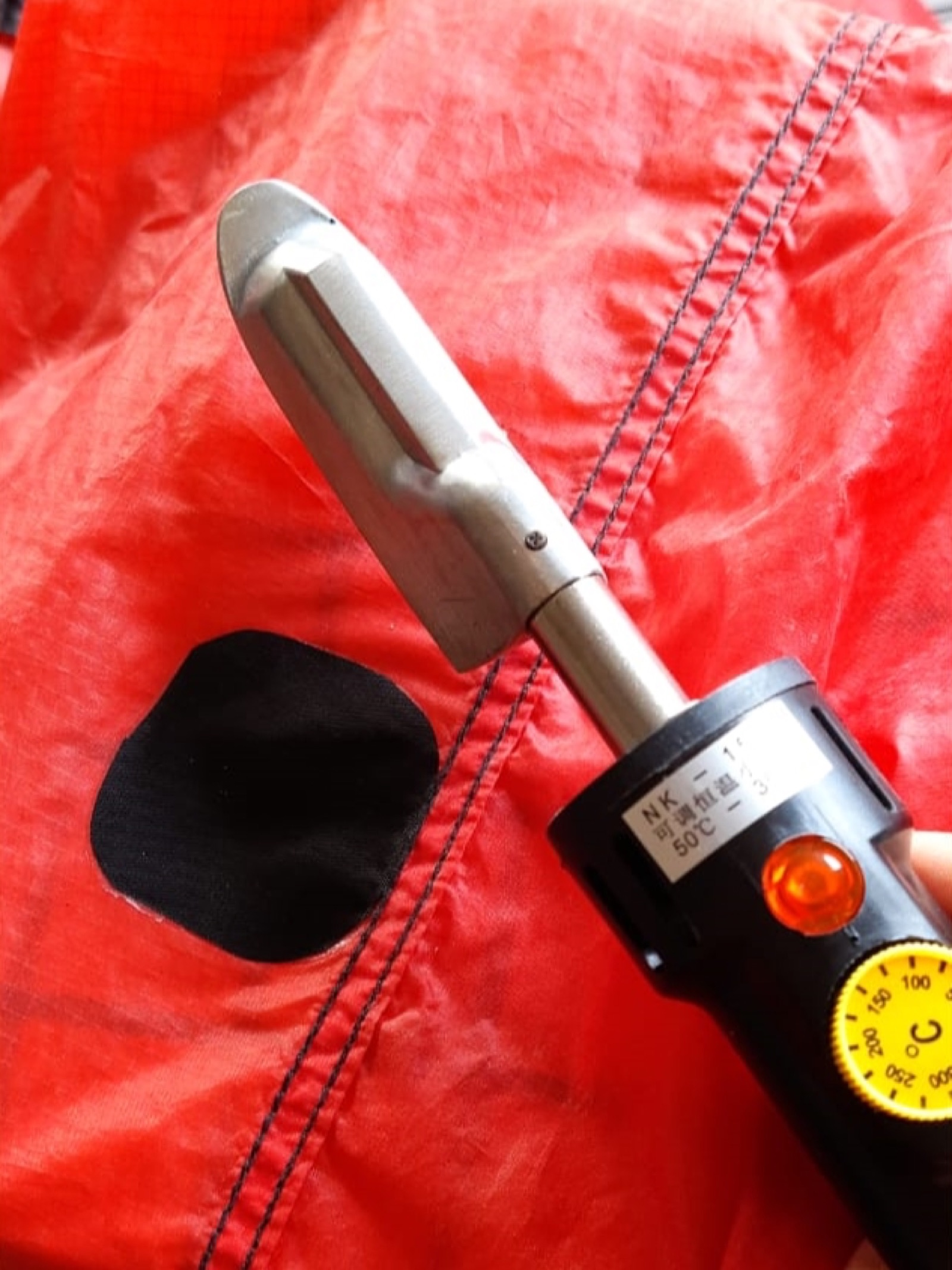Patching a tear in PU-coated tent fabric.