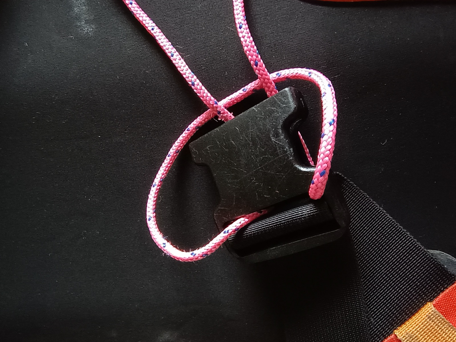 Improvised cord fix for a snapped plastic buckle.